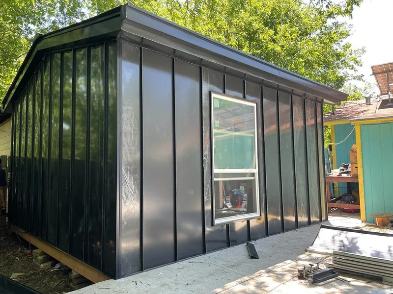 Black standing seam metal wall panels for Roof Inspection in Bridge City