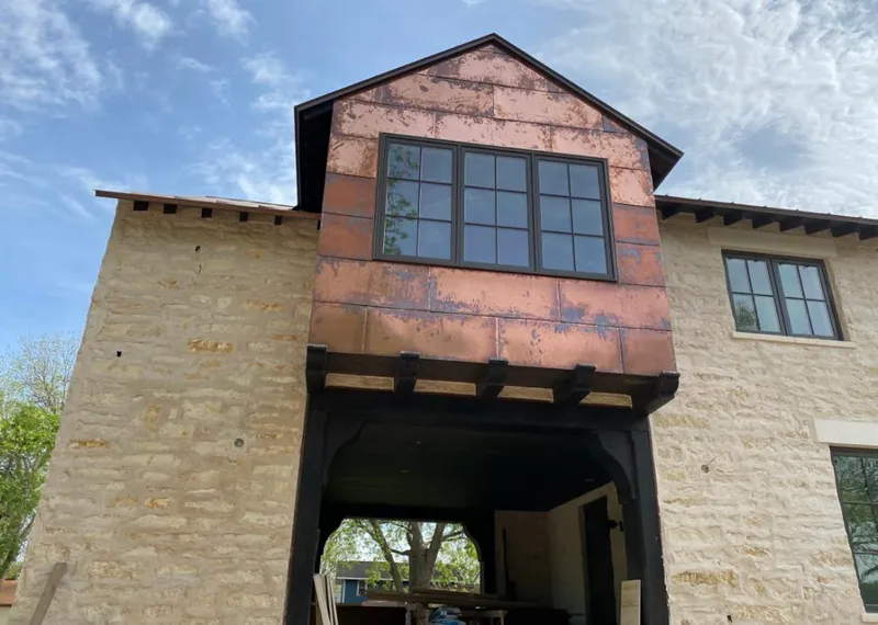 Copper metal panel facade on a stone building for Metal Roof Coating in Bridge City